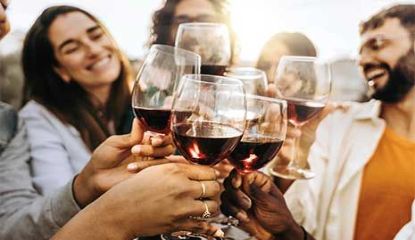 Friends toasting glasses of red wine